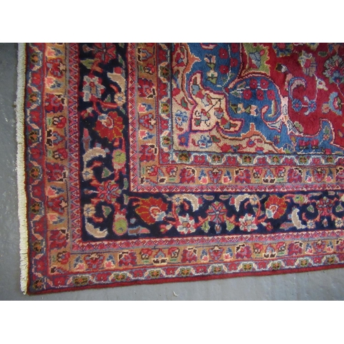 691 - Middle Eastern design Mashad carpet on a mainly red ground with multi-coloured stylised floral and f... 