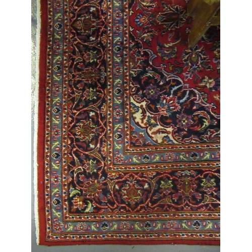 692 - Middle Eastern design Kashan carpet on a multi-coloured stylised flower head and foliage design, the... 