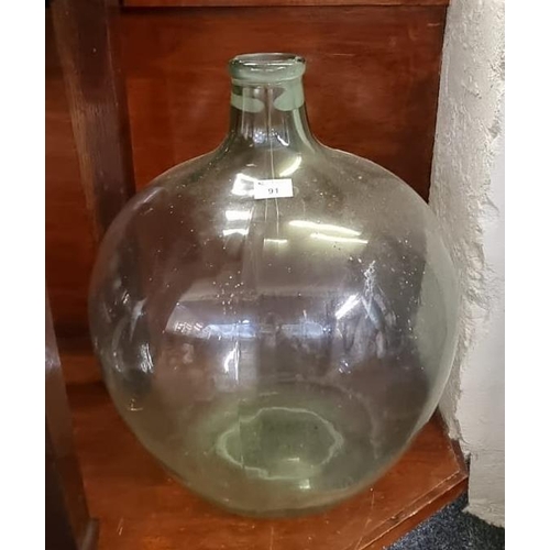 91 - Traditional green tinted glass carboy. 58cm high approx.
(B.P. 21 + VAT)