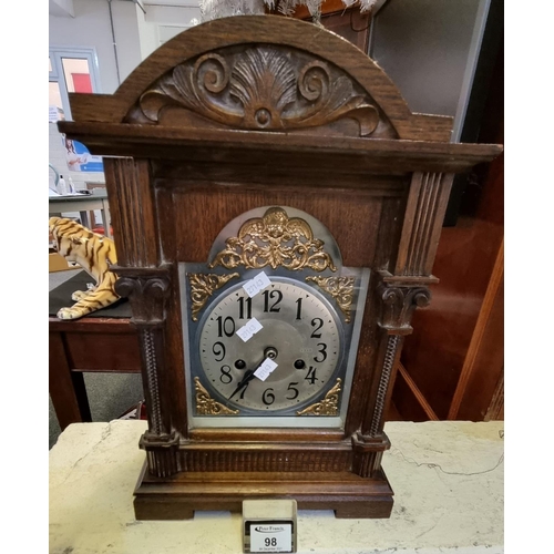 98 - Early 20th Century oak two train architectural design mantel clock having silvered dials with gilded... 