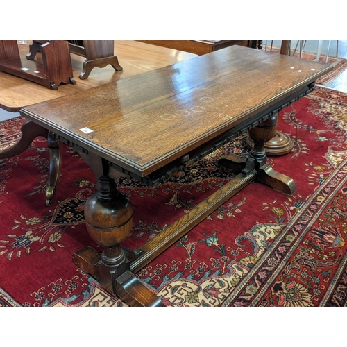 644 - Mid Century oak dining table on baluster turned cup and cover supports with centre stretcher. 138cm ... 