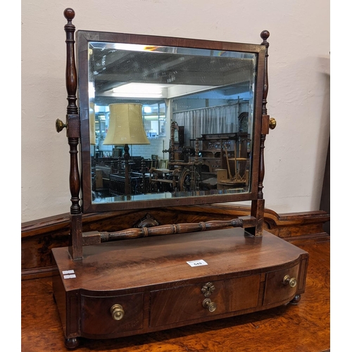 649 - 19th Century mahogany bow front bevel plate bedroom or toilet swivel mirror, having turned supports ... 