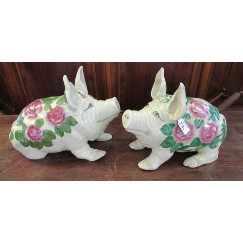 72 - A pair of reproduction Wemyss style ceramic pigs, transfer printed with roses and foliage. Unmarked.... 