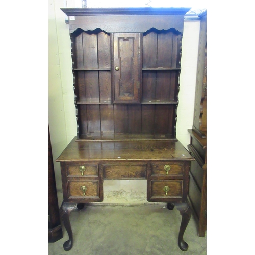 473 - Early 20th Century oak, Jacobean style, two stage, rack backed dresser, the moulded cornice above ca... 