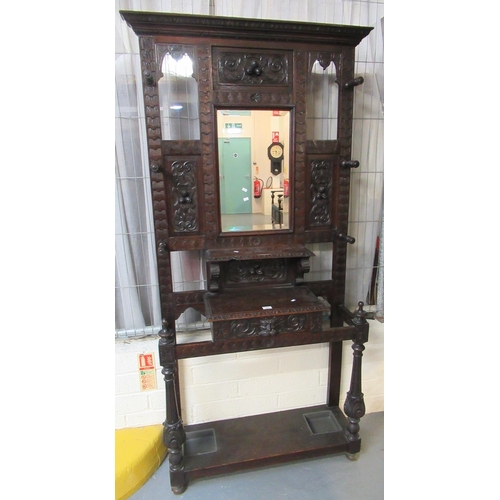 491 - Late Victorian, heavily carved oak, mirror backed hallstand, overall with carved flowers, flower bud... 