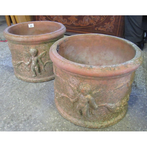 495 - Pair of weathered terracotta planters of circular form with moulded decoration of cherubs to the ext... 