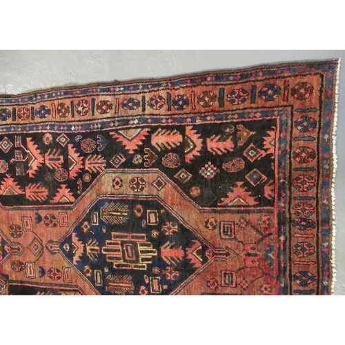 497 - Iranian Koliaie rug on a salmon and blue ground with central geometric medallions, the borders with ... 