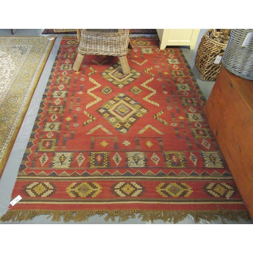 499 - Red ground Kelim rug, overall with multicoloured geometric designs, 160 x 245cm approx.
(B.P. 21% + ... 