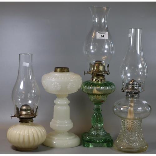 74 - Three early 20th century single oil burner oil lamps with clear moulded and opaline glass reservoirs... 