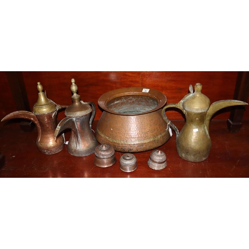 83 - Collection of Middle Eastern copper and brass items to include; three Dallahs, large beaten copper b... 