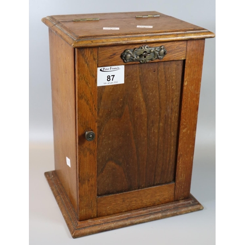 87 - Early 20th century oak single door blind paneled smoker's cabinet, the interior revealing clay and o... 