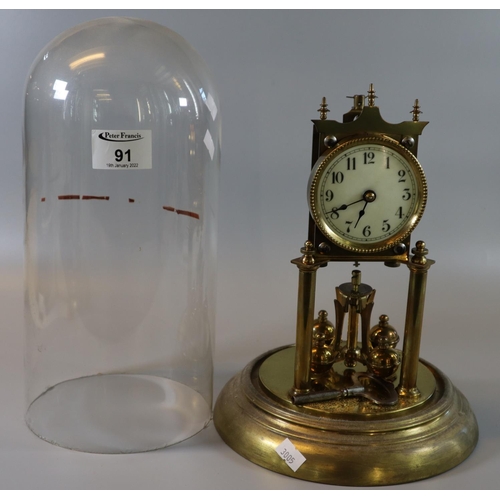 91 - Early 20th Century brass perpetual motion clock, architectural design, with key and glass dome. 
(B.... 