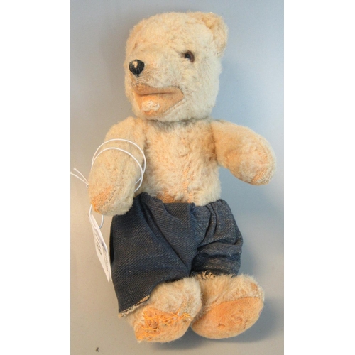 118 - Small vintage teddy bear with glass eyes, stitched nose and movable limbs, wearing a pair of trouser... 