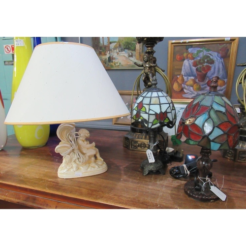 442 - Two similar small modern Tiffany design table lamps, together with another table lamp, the base mode... 