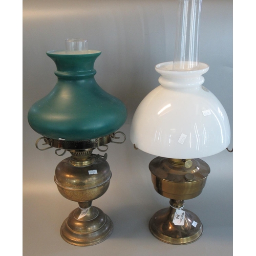 84 - Two similar oil burner lamps with opaline glass shades on brass reservoir and base. (2)
(B.P. 21% + ... 