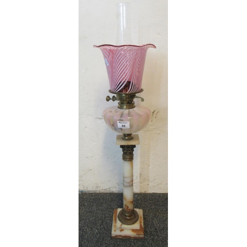 88 - Early 20th Century double oil burner lamp having cranberry shade, pink and white opaline glass reser... 