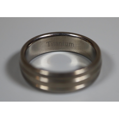 228 - Titanium band ring.  Ring size U.  Approx weight 4.3 grams.
(B.P. 21% + VAT)