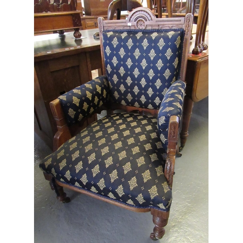 435 - Edwardian walnut framed upholstered open arm chair on turned legs and castors.
(B.P. 21% + VAT)