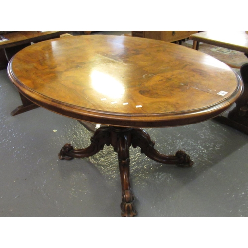 500 - Victorian walnut loo table of oval form, the moulded top above a good quality carved foliate quatraf... 