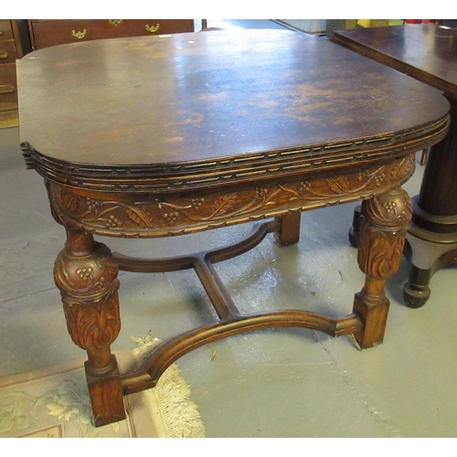 511 - Early 20th century extending oak dining table, the frieze and baluster supports overall with  vine a... 