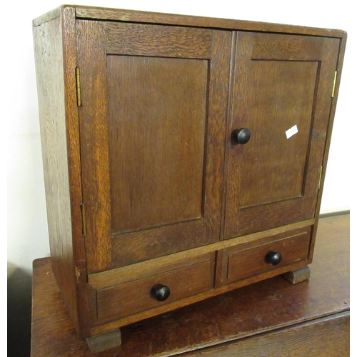 514 - 1930's design oak two-door blind panel apprentice type cabinet. 41 x 18 x 41cm approx.
(B.P. 21% + V... 