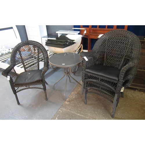 521 - Set of four wicker garden chairs with seat cushions, together with a small, metal framed pedestal ta... 