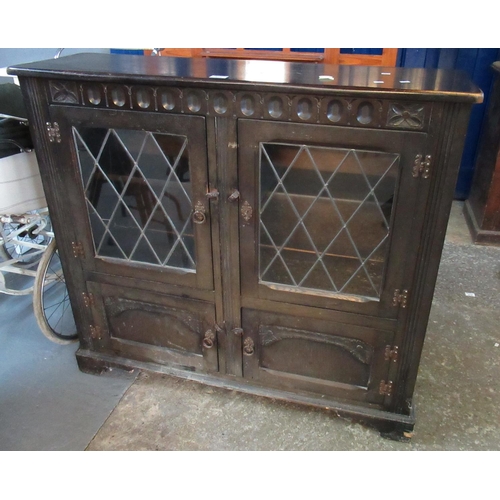 522 - Mid 20th century stained oak lead glazed bookcase cupboard. 110cm wide approx.
(B.P. 21% + VAT)