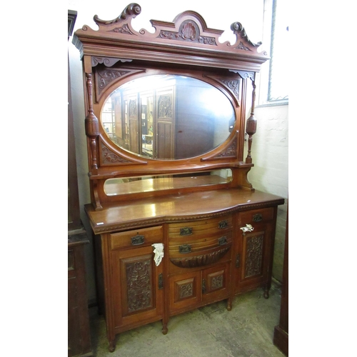 525 - Edwardian walnut breakfront mirror-back sideboard with oval bevel plate mirror under a broken arch p... 