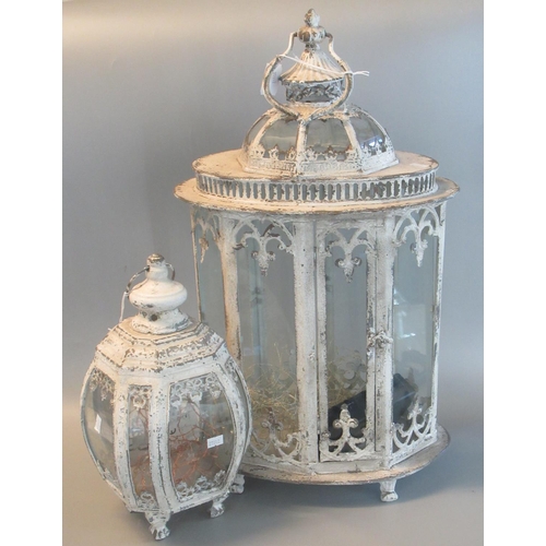 81 - Modern shabby chic design metal and glass lantern, together with a similar smaller hanging lanters. ... 