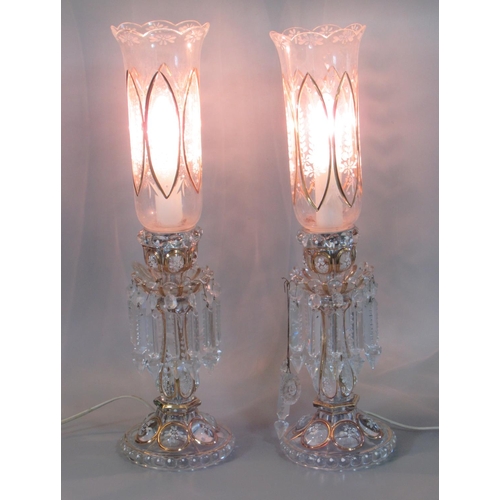 101 - Pair of Victorian bohemian clear glass lustre candle sticks, now converted to electricity, having tu... 