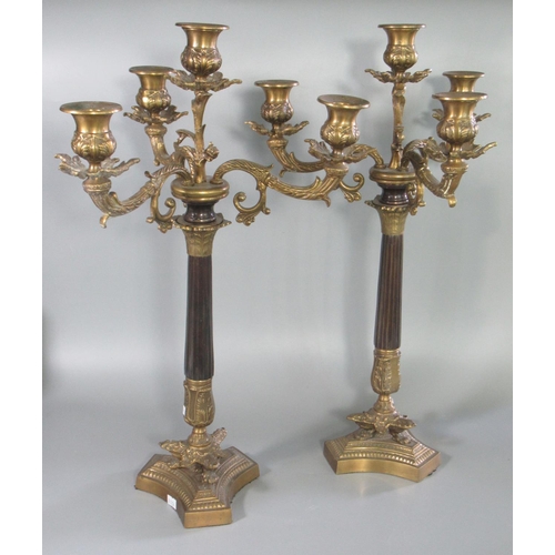 103 - Pair of classical design gilt metal three-branch table candelabra on fluted columns and stylised paw... 