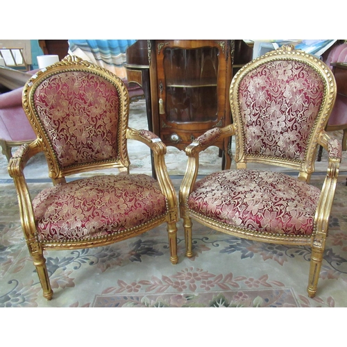 376 - Pair of French design gilded gesso open arm chairs, the arched and padded upholstered backs with stu... 