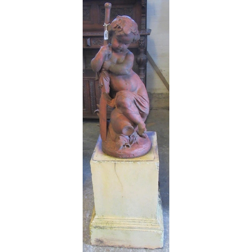 488 - Cast iron garden figure of a cherub holding a paddle, seated on amphora. 73cm high plus associated t... 