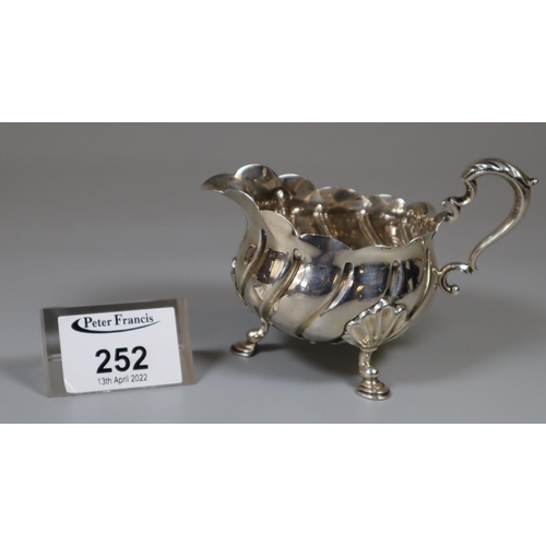 252 - Late Victorian silver cream jug raised on three hoof feet. London, 1895. 3.25oz troy approx.
(B.P. 2... 