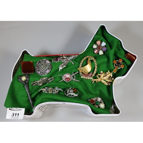 311 - A collection of vintage brooches in a Highland Terrier tin, including two Victorian specimen brooche... 