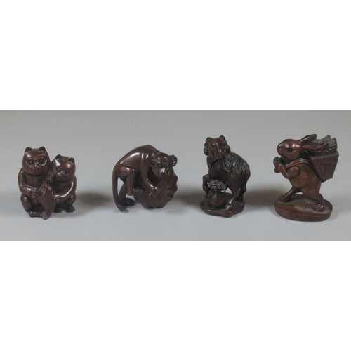 334 - Collection of four Japanese carved netsukes to include monkey, ram, rabbit, etc. Signed character ma... 