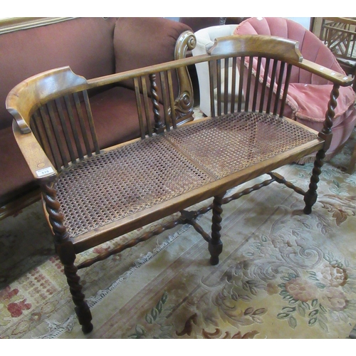 515 - Early 20th century walnut two seater parlor type sofa with cane seat on barley twist supports.
(B.P.... 