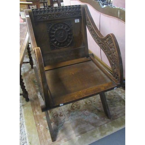 516 - Early 20th century oak Canterbury type ecclesiastical X-frame elbow chair with carved decoration.
(B... 