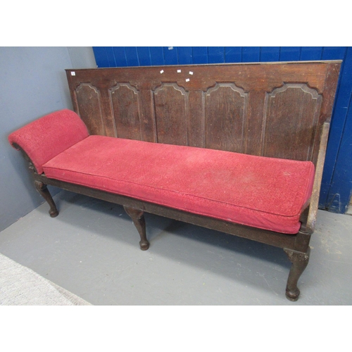 569 - 18th century oak settle having five moulded and fielded shaped panels, shaped open arms, standing on... 