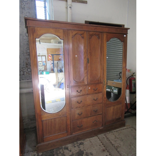 592 - Edwardian three section mirror door compactum type wardrobe with cupboard and drawers to the centre.... 