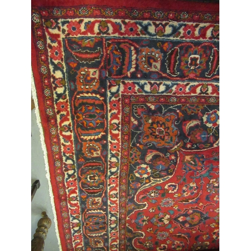 615 - Large red ground Persian Mashad carpet with floral medallion designs. 392 x 370cm approximately.
(B.... 