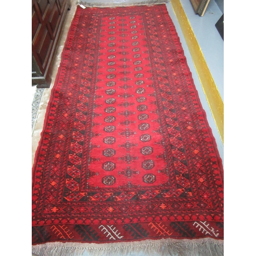 618 - Middle Eastern red ground bokhara style runner. 259 x 110cm approx.
(B.P. 21% + VAT)