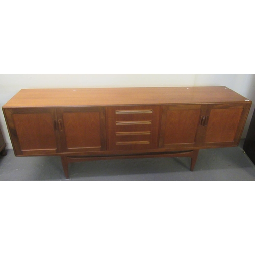 518 - G-Plan teak long sideboard with two pairs of panel cupboards flanking four centre drawers, on taperi... 