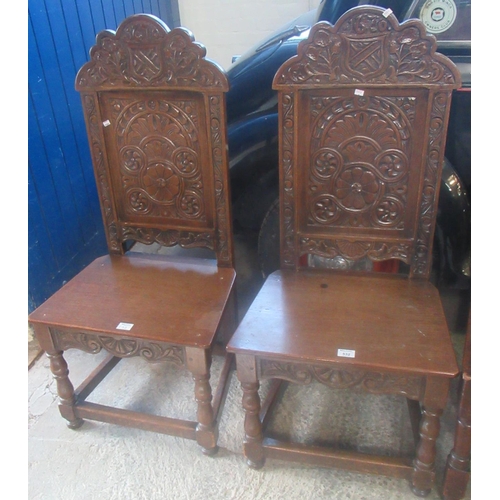 532 - Pair of oak side chairs in 17th century style with armorial and foliate moulded back and solid seats... 