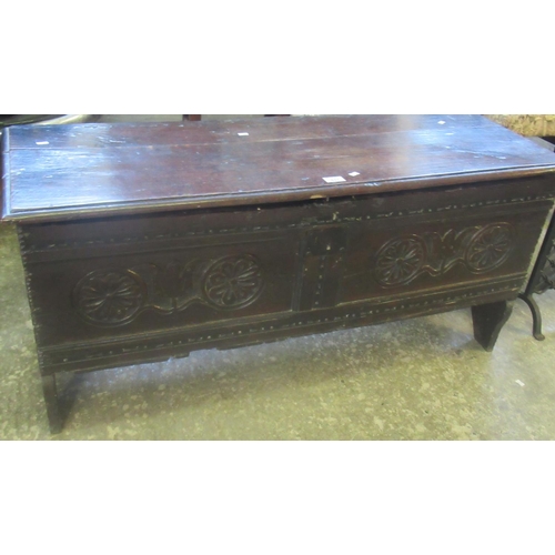 537 - 17th century oak plank chest with moulded top on staple hinges, the front panels with rosette and fo... 