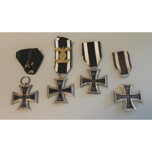 97 - Three German WWI Iron Crosses (second class EK1914) one with standard ribbon and one with triangular... 