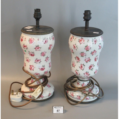 87 - Pair of floral decorated ceramic baluster shaped electric table lamp bases. 30cm high approx. (2)
(B... 