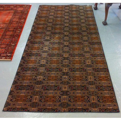 529 - Modern middle eastern design carpet on a multicoloured geometric and foliate ground.  410x172cm appr... 