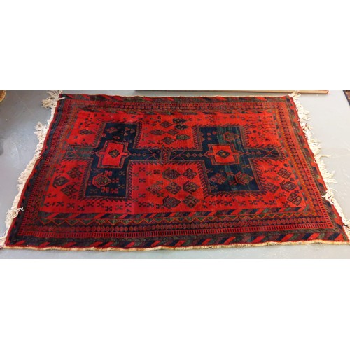 533 - Middle eastern design red ground carpet having geometric floral and foliate designs.
 (B.P. 21% + VA... 