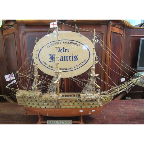 70 - Well made wooden model of Nelson's flagship HMS Victory. On display stand. Overall 100cm long approx... 